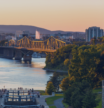 View of the Alexandra Bridge connecting Gatineau and Ottawa at sunset.